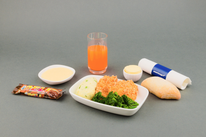 Hot children's meal - chicken schnitzel with mashed potatoes, peas and vegetables, sweet curd, butter, apple juice, a white roll